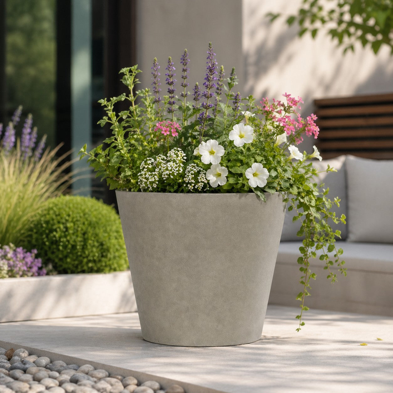 Hortus Lite - Aged Effect Plastic Planter -Vintage - Dia 30 x H27cm lifestyle - fibreglass stone-effect planter with lush greenery on modern garden terrace