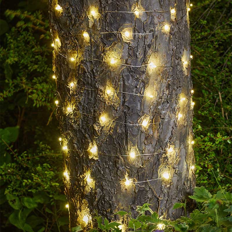 Ultra Solar Firefly String Lights, 200 LEDs lifestyle - planter with plants on garden setting