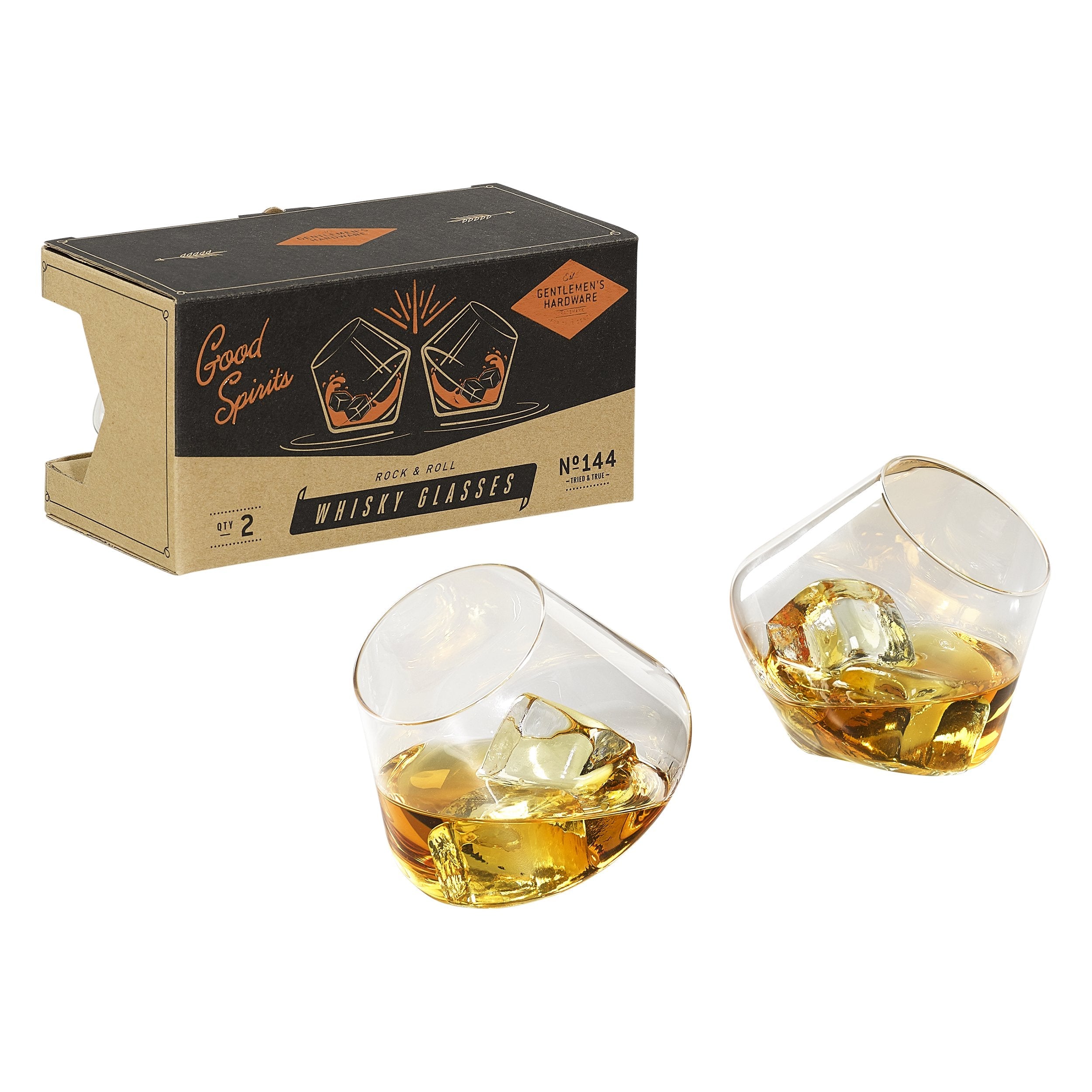 Set of two rocking whiskey glasses filled with whiskey and ice next to gift box