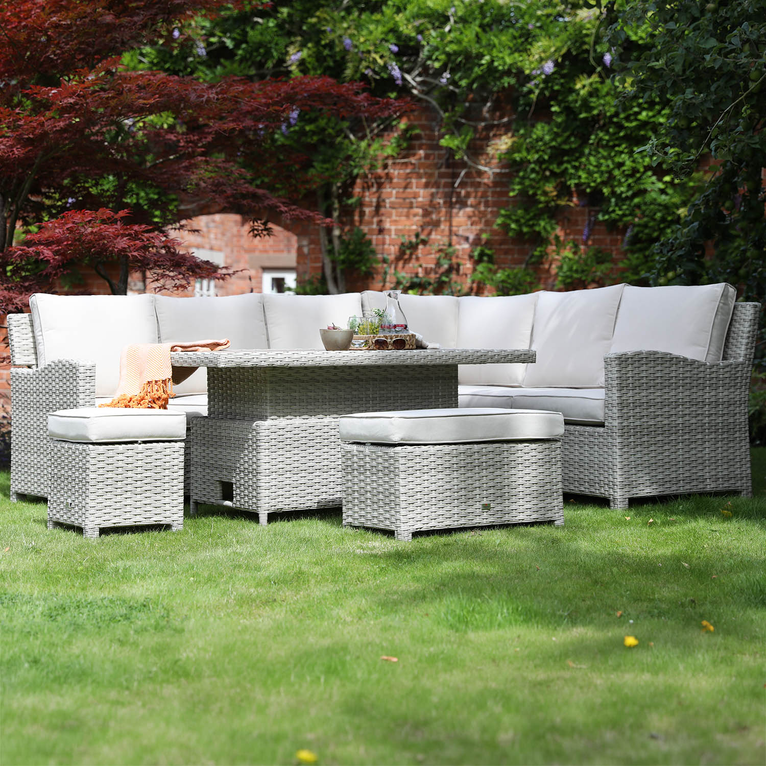 Outdoor patio furniture set with fire pit table in a garden setting
