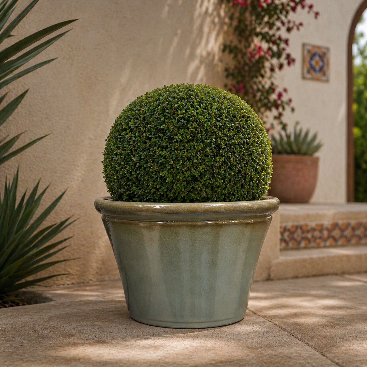 Hortus Lite - Glaze Plastic Rolled Rim Planter - Olive Green- Dia 40 x Height 26cm lifestyle - fibreglass stone-effect planter with lush greenery on modern garden terrace
