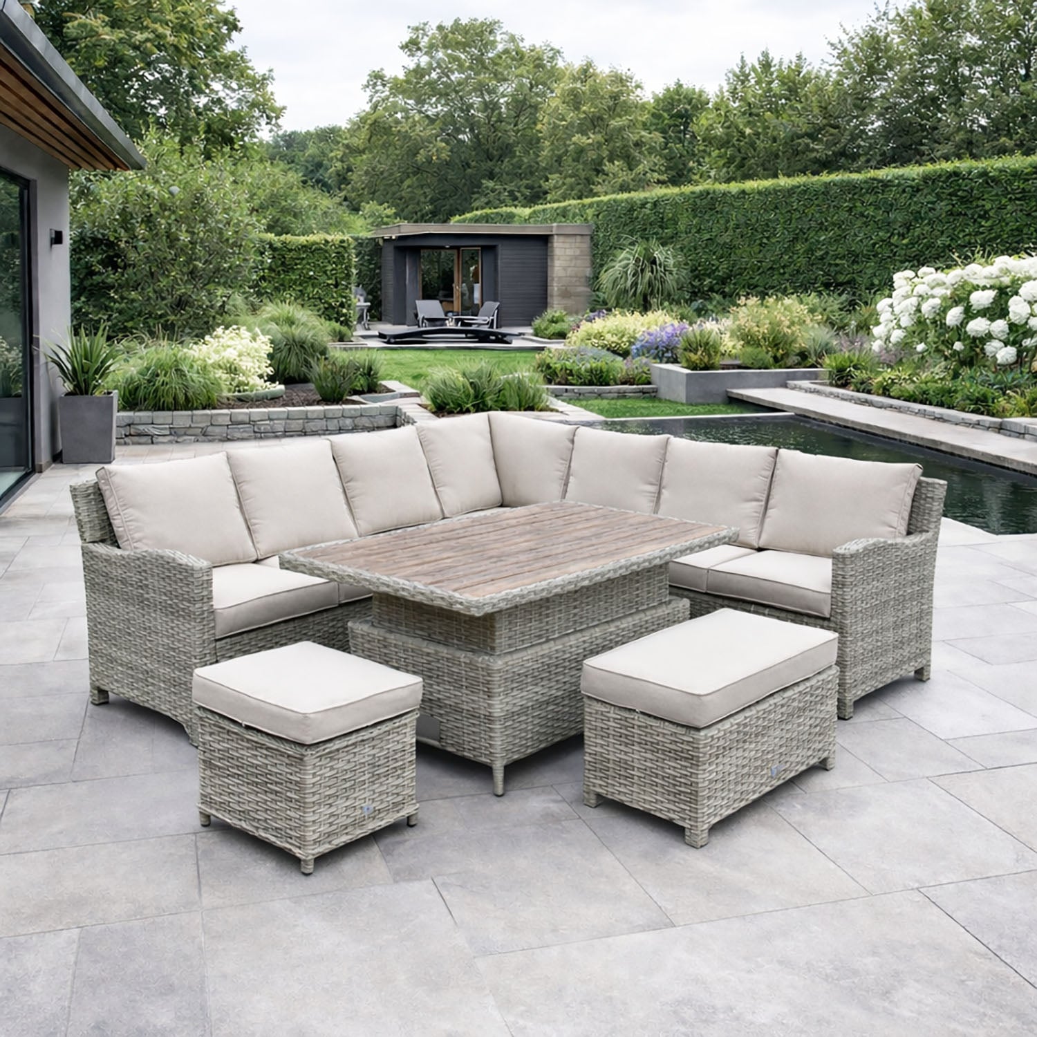 Outdoor patio set with sectional sofa and table on a paved patio area.