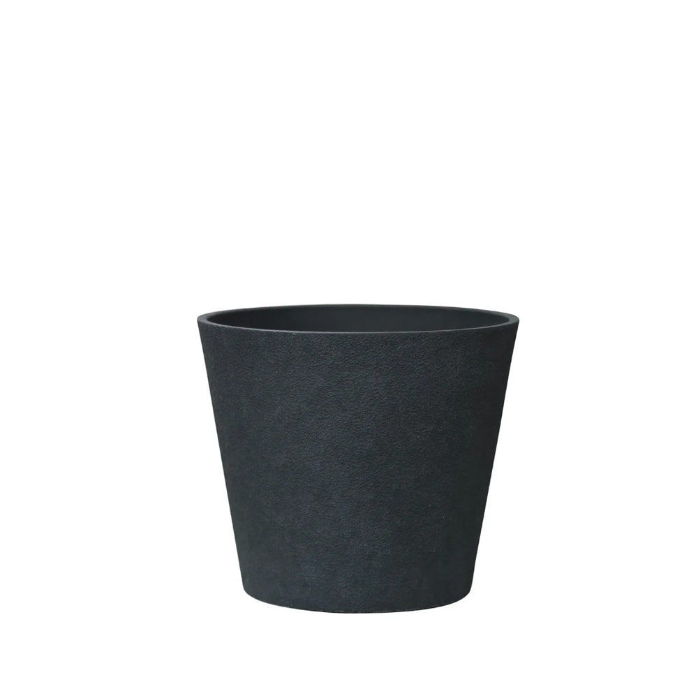 Hortus Lite - Aged Effect Plastic Planter - Charcoal Black - Dia 30 x H27 lifestyle - fibreglass stone-effect planter with lush greenery on modern garden terrace