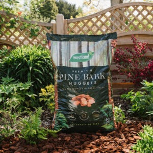 Premium Pine Bark Nuggets in garden border