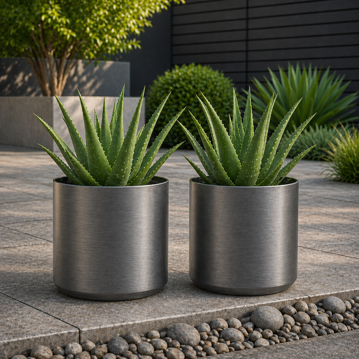 Hortus Lite - Metallic Look Plastic Cylinder Planter - Brushed Steel - Dia28 x H28cm lifestyle - metal cylinder planter with lush greenery on modern garden terrace