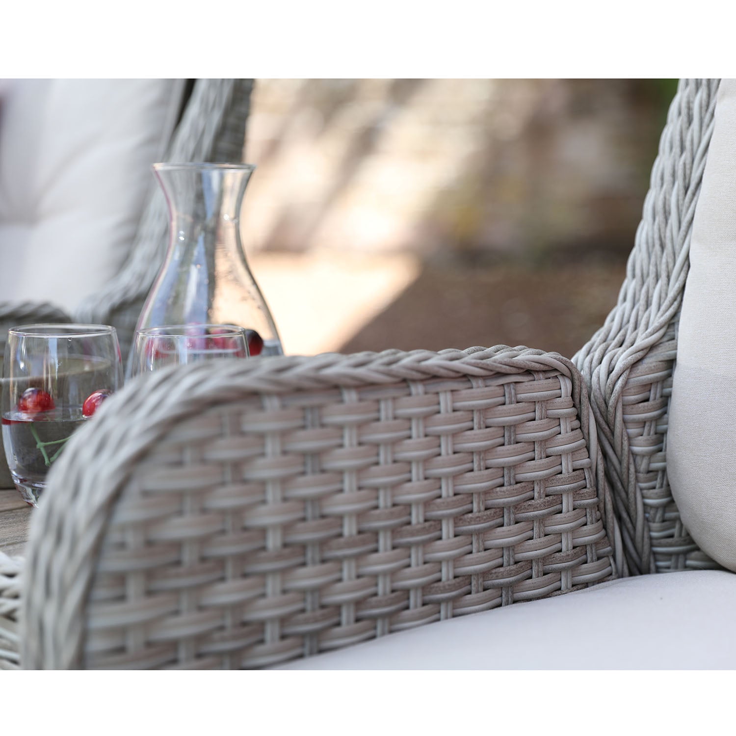 Close-up of a wicker chair with a blurred outdoor background