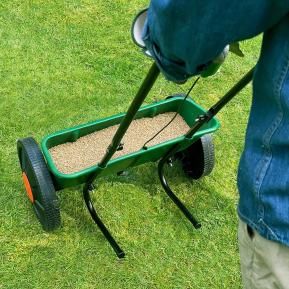 Miracle-Gro Drop Spreader in use on lawn